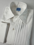 Close-up of a white dress shirt with pleated details on a gray background